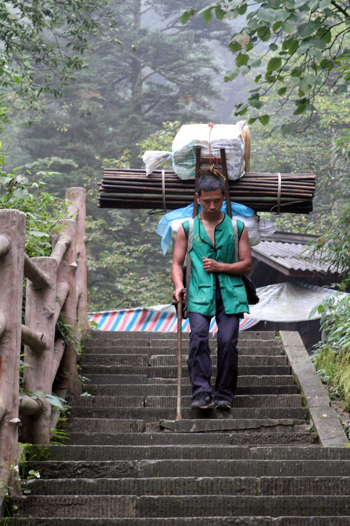 A porter brings materials down Mt. Emei, China, to the various stations where they sell water, snacks and the occasional noodle.
